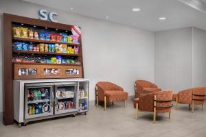 a waiting room with chairs and a soda machine at Hampton Inn & Suites Clinton in Clinton +29 photos