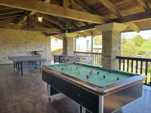 a billiard room with a pool table and two tables at Casa Bama in Bama