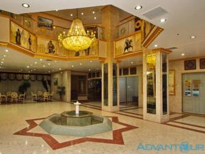 a large lobby with a fountain in the middle of it at Ak Altyn in Ashgabat