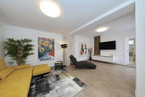 a living room with a couch and a tv at Holiday house Luca with private pool in Vrsi