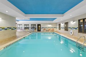 a large swimming pool with a blue ceiling at Hampton Inn & Suites Claremore in Claremore