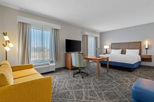a hotel room with a bed and a desk at Hampton Inn & Suites Claremore in Claremore