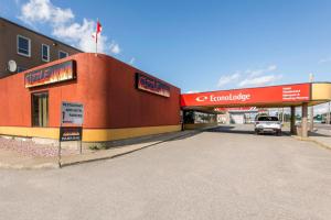 a car parked in front of a building at Econo Lodge in Sudbury