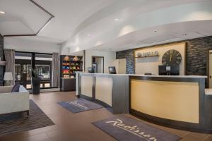 a hotel lobby with a clock on the wall at Radisson Hotel Grand Rapids Riverfront in Grand Rapids