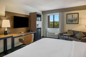 a hotel room with a bed and a tv at Radisson Hotel Grand Rapids Riverfront in Grand Rapids