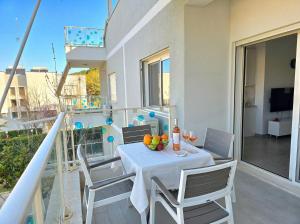a table with a bowl of fruit on a balcony at Sunny Beach Apartments - 146 in Mullini i Danit +23 photos