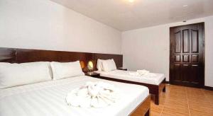 a bedroom with two beds with white sheets at Palette Boracay Isle by The White Beach in Boracay