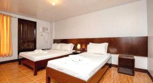 a hotel room with two beds and a table at Palette Boracay Isle by The White Beach in Boracay +43 photos