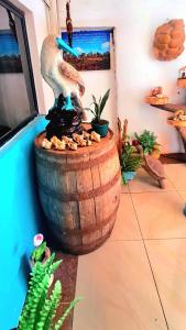 a statue of a pelican standing on top of a barrel at Casa Galarous Island in Puerto Ayora