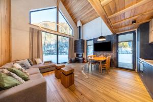 a living room with a couch and a table at Vama Chalet in Vama Buzăului