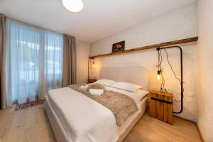 a bedroom with a large bed and a large window at Vama Chalet in Vama Buzăului +68 photos