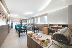 a restaurant with plates of food on a counter at A&EM - The Petit Hotel in Ho Chi Minh City