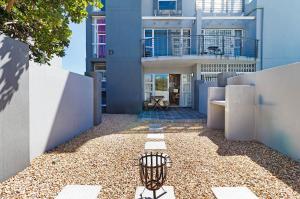 a building with a bird cage in front of it at The Sands Cottage in Cape Town