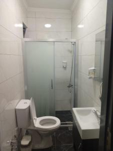a bathroom with a shower and a toilet and a sink at ROSe OTEL in Ezine +61 photos