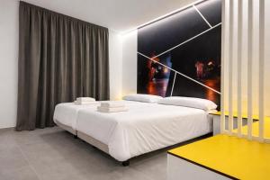 a bedroom with two beds and a yellow table at Pension Sarria in Sarria