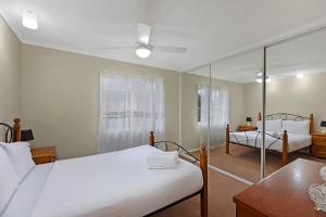 a bedroom with two beds and a table at Fravent house in Toukley