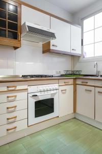 a kitchen with white cabinets and a stove top oven at For You Rentals AvenidaAmerica apartment AVA24 in Madrid