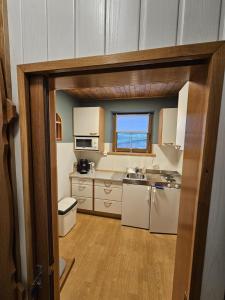 a kitchen with white appliances and a window at Mirnockblick Apartments 2 in Radenthein