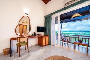 a room with a desk and a mirror and a balcony at Chaarya Lake in Tissamaharama