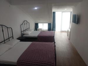a hotel room with two beds and a window at ROSe OTEL in Ezine
