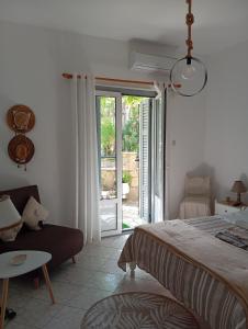 a bedroom with a bed and a sliding glass door at Maria I in Chorto