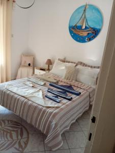 a bedroom with a large bed with a painting on the wall at Maria I in Chorto +2 photos