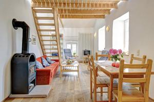 a living room with a wood stove and a table at Nengshof Ferienhaus Ehrenpreis in Wißmannsdorf