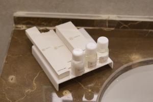 a group of bottles on a counter in a bathroom at RT Serene Hotel - Larkana in Lāhori +113 photos