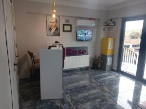 a living room with arosis sign on the wall at ROSe OTEL in Ezine
