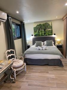 a bedroom with a bed and a table and a bench at Maranatha, front de mer avec plage in Porto-Vecchio +242 photos
