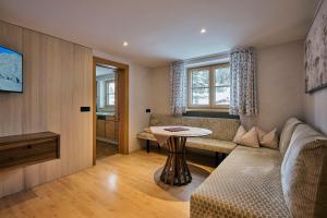 a living room with a couch and a table at Pension Regina in Lech am Arlberg