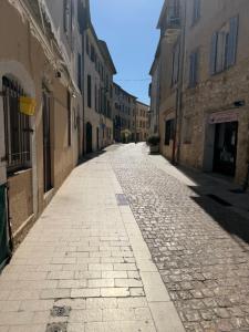 an empty street in an alley between buildings at Appartement La Colle sur Loup in La Colle-sur-Loup
