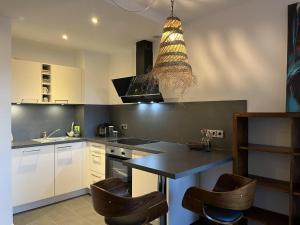 a kitchen with white cabinets and a table and chairs at Ferienwohnung Rolofs in Bad Nenndorf