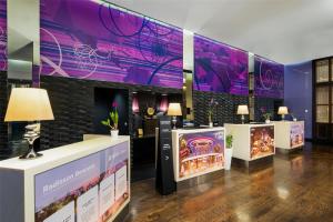 a room with purple walls and tables with lights at Radisson Suites Bangkok Sukhumvit in Bangkok +109 photos