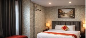 a bedroom with a bed and a painting on the wall at rashik stayzz in Shimla