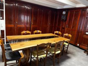 a conference room with a wooden table and chairs at Maison de famille au plateau du Mezenc in Les Vastres