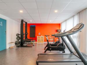 a gym with a treadmill and chairs in a room at ibis Styles Bordeaux Lac Bruges in Bordeaux