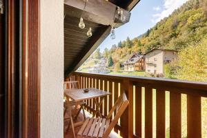 a balcony with a table and chairs and a view at Val di Sole Apartment in Monclassico