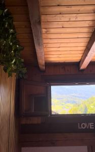 a television on the ceiling of a room at Val di Sole Apartment in Monclassico