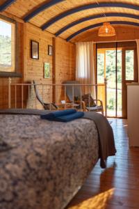 a bedroom with a bed and a living room at Finca la montaña roja in Almogía +66 photos