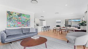 a living room with a couch and a table at 21 Forever in Pokolbin