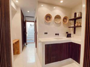 a bathroom with a sink and a counter top at Archo Suites Pythagoreio in Pythagoreio +20 photos