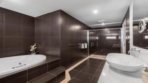 a bathroom with a large tub and a sink at Dashaz Dream - The Vintage in Pokolbin
