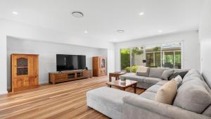 a living room with a couch and a flat screen tv at Dashaz Dream - The Vintage in Pokolbin
