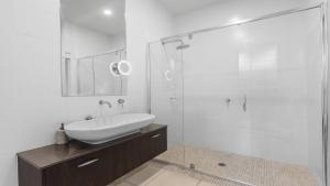 a bathroom with a sink and a glass shower at Dashaz Dream - The Vintage in Pokolbin +7 photos