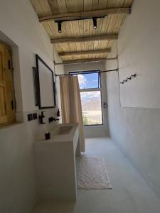 a bathroom with a sink and a window at BROQ in Skardu