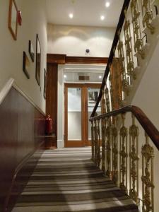 
a hallway with stairs leading up to a staircase at Garden View Hotel in London
