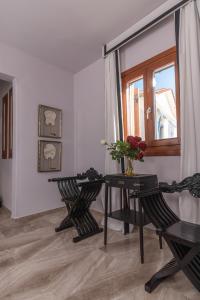 a room with two chairs and a table and a window at Archo Suites Pythagoreio in Pythagoreio