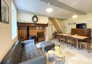 a living room with a couch and a table and a fireplace at Gite de l'isarce in Montaut