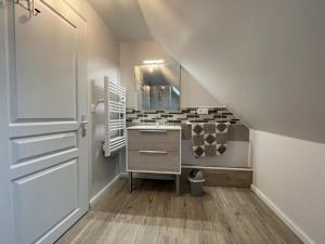 a bathroom with a sink and a mirror and a staircase at Gite de l'isarce in Montaut +22 photos